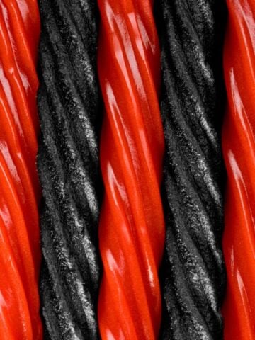 A closeup of alternating red and black licorice sticks