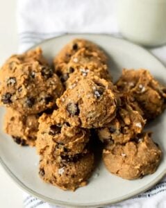gluten free chocolate chip chickpea cookies stacked on white pottery