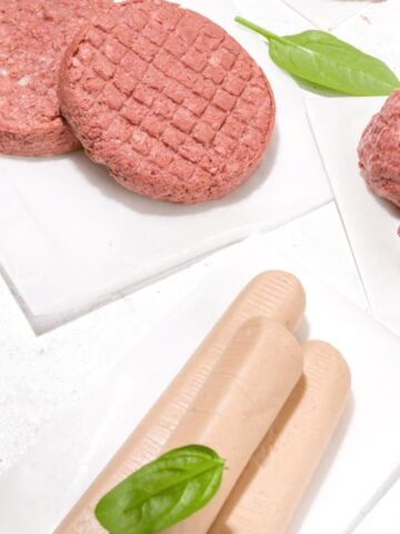 gluten free plant based hamburgers meatballs and hot dogs on white background