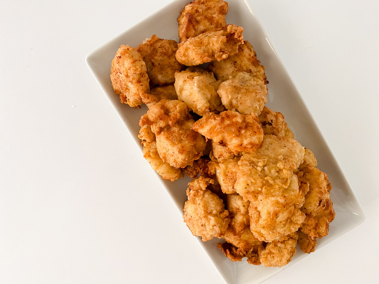 Cooked Copycat Chick-fil-A Chicken Nuggets on a white, rectangle serving platter