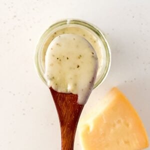 thumbnail image of garlic parmesan sauce in jar and on wooden spoon