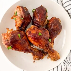 thumbnail image of gluten free bbq chicken drumsticks on white plate