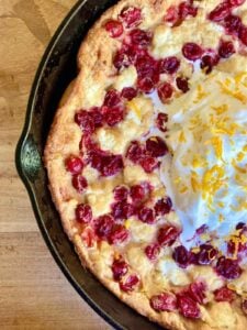 gluten free cranberry cheesecake dutch baby in skillet