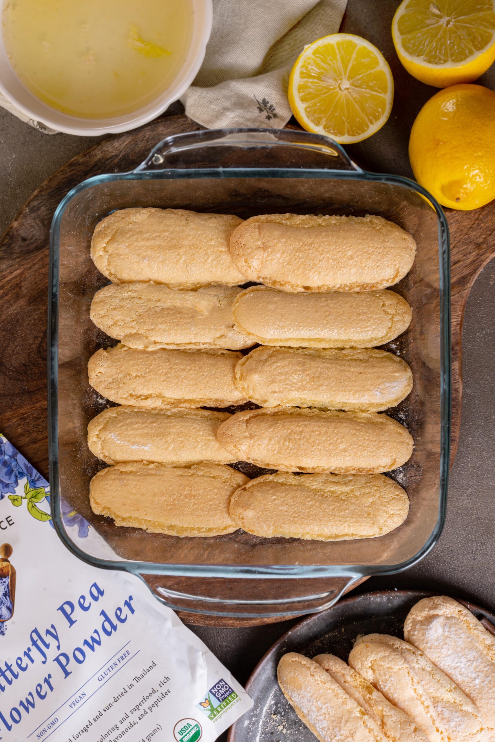gluten free lady fingers in pan soaking in lemoncello